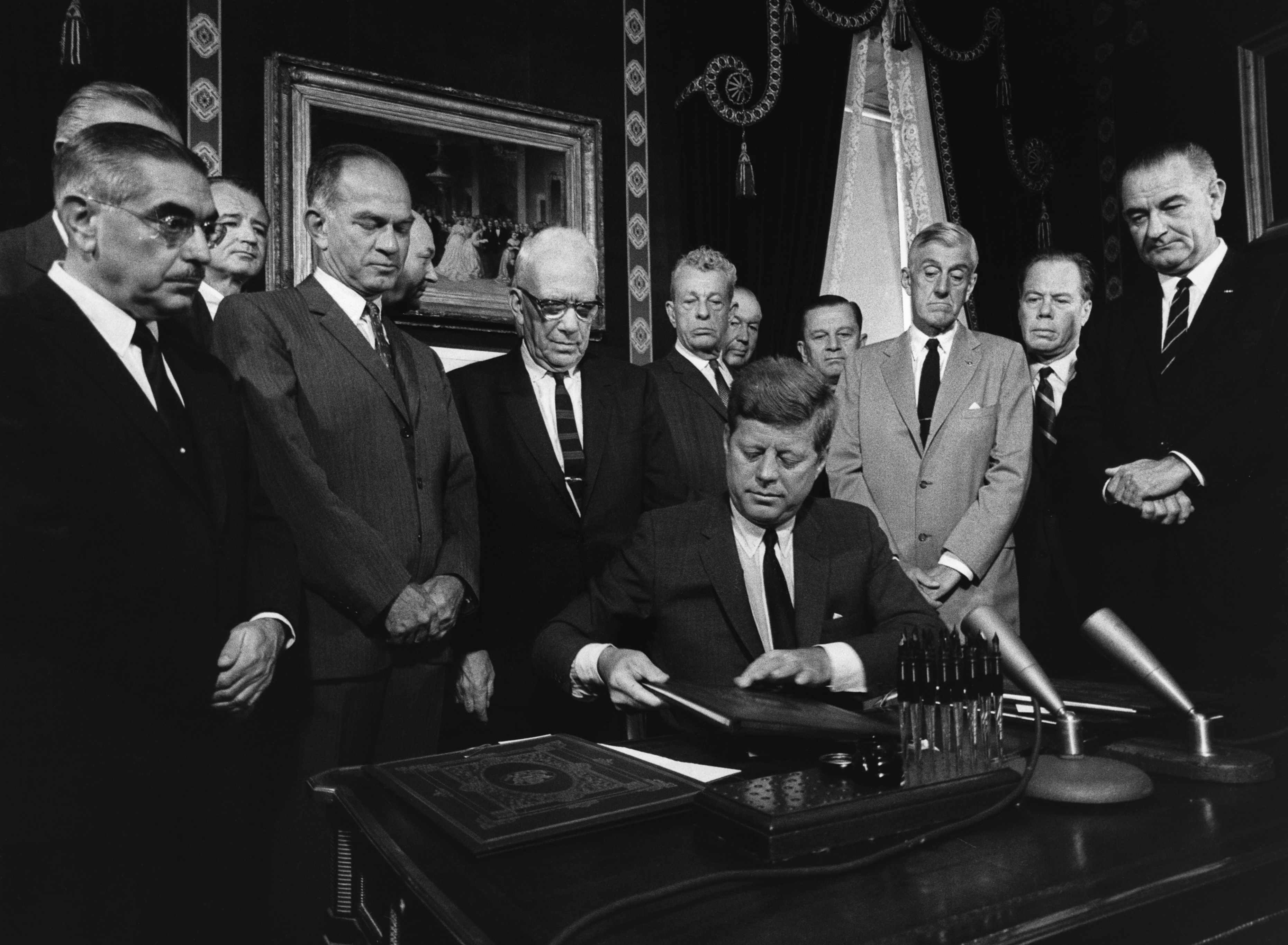 JF Kennedy signs the Partial Nuclear Test Ban Treaty in July 1963